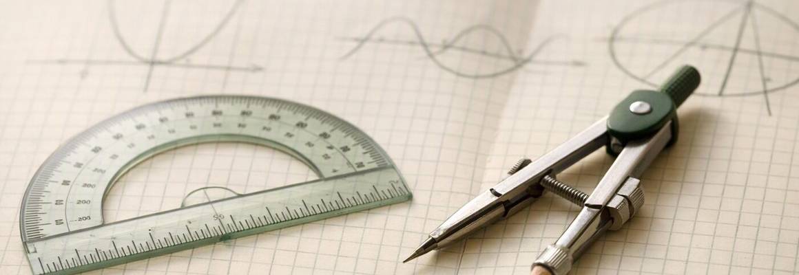 A protractor and compasses on squared paper with sketched graphs